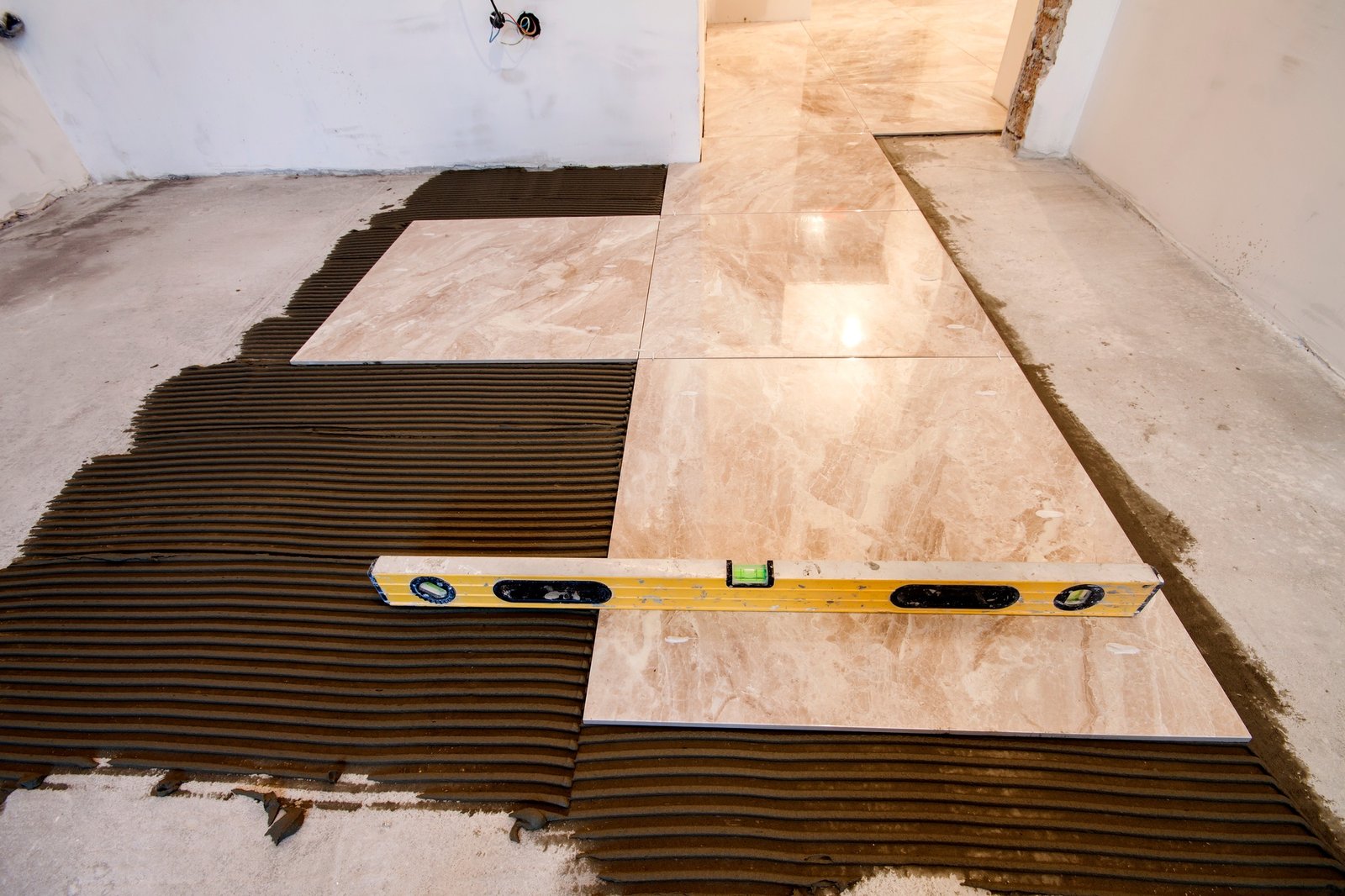 Ceramic tiles and tools for tiler. Floor tiles installation. Home improvement, renovation - ceramic